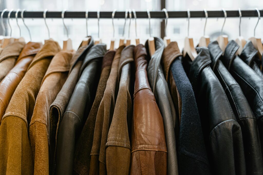 pexels-photo-7679455-7679455 A close-up view of leather jackets hanging neatly on a rack inside a store.